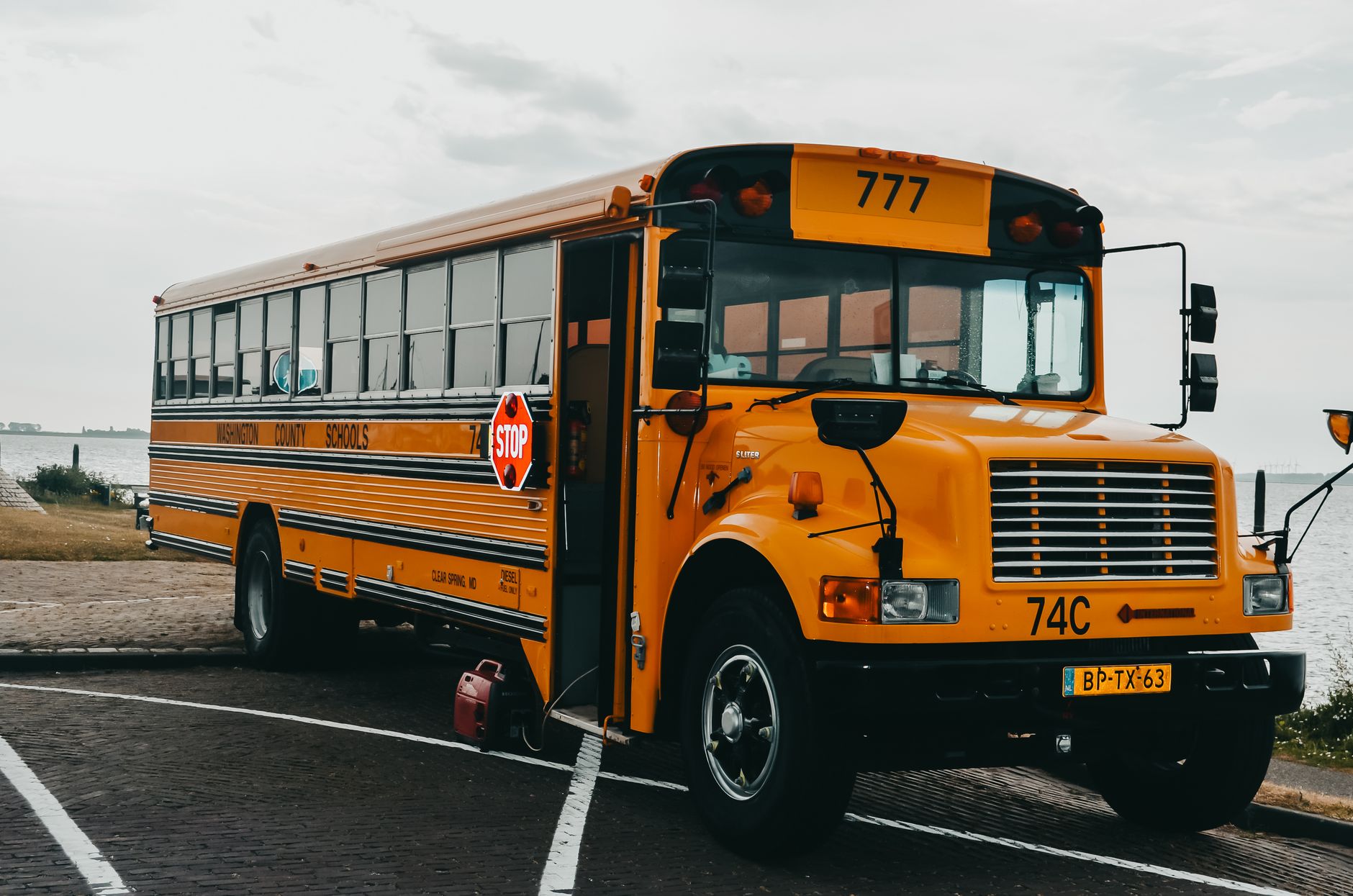 A row of school buses parked at a depot