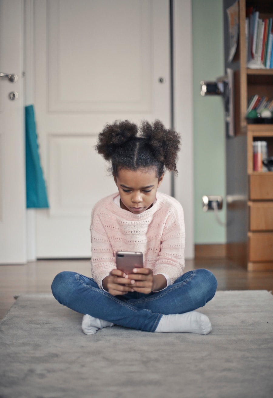 A young girl looking at a phone at home